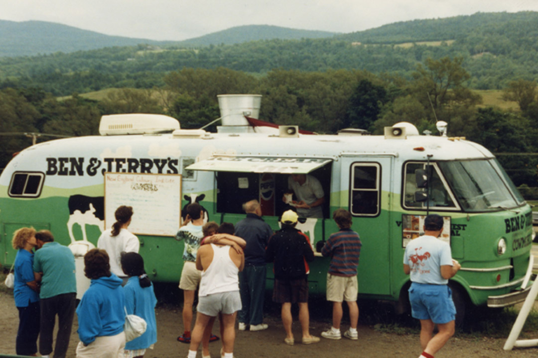 Ben & Jerry's Cow bus with people waiting in line