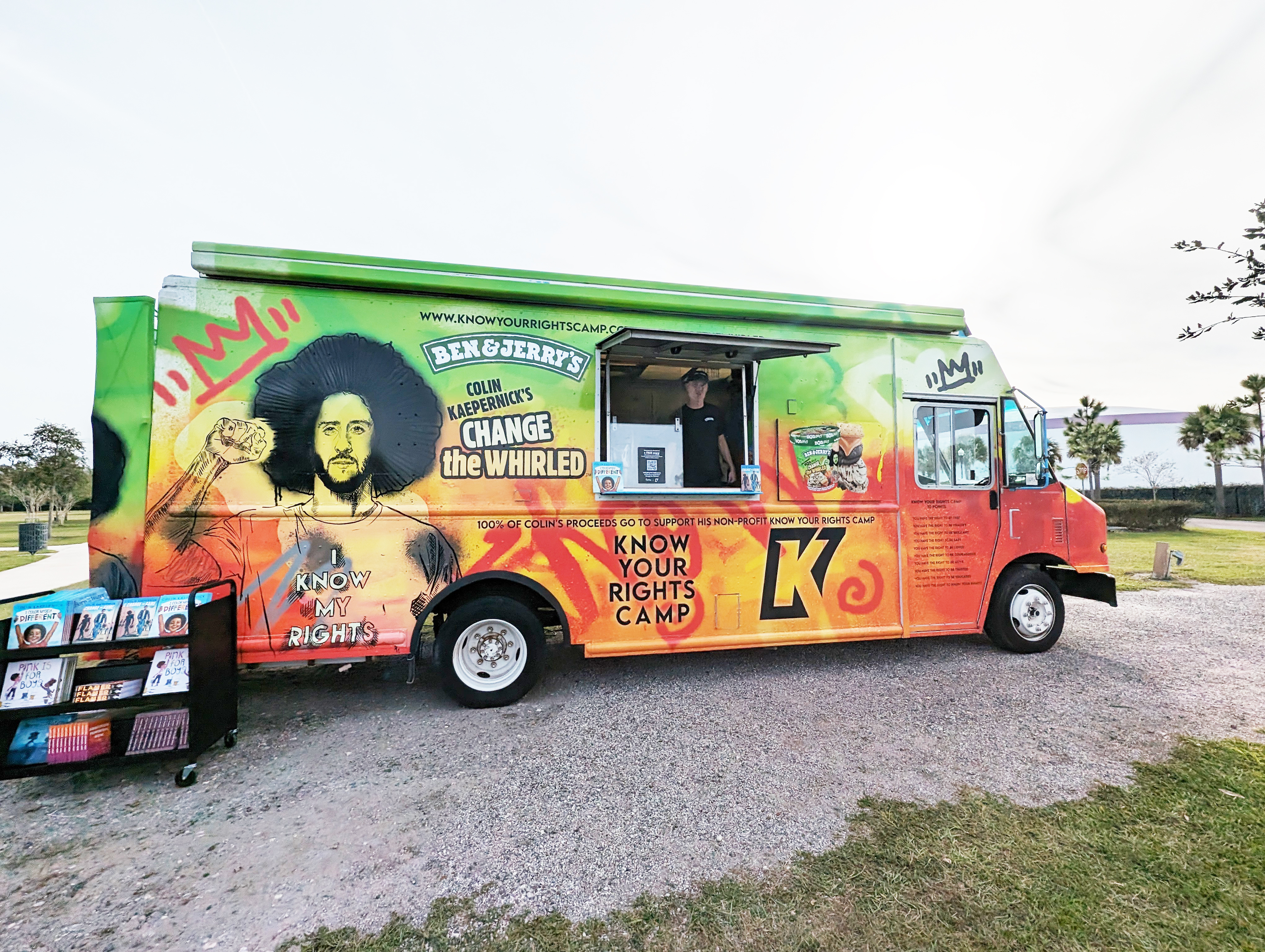 Ben & Jerry's scoop truck with a rack of banned books alongside.