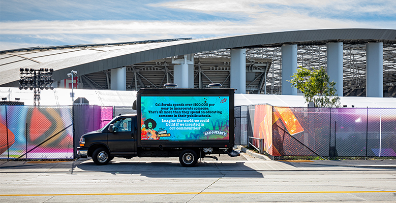 Billboard on the side of a truck in Los Angeles that reads: California spends over $100,000 per year to incarcerate someone. That's 4x more than they spend on educating someone in their public schools. Imagine the world we could build if we invested in our communities?