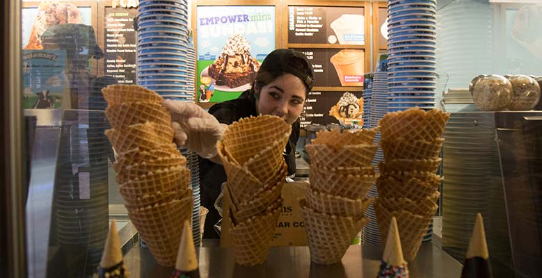 Scooper grabs a waffle cone at the Scoop Shop.