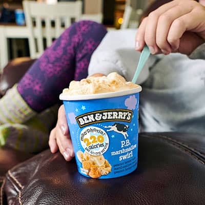 Person holding pint of Ben & Jerry's PB Marshmallow Swirl Moo-phoria light ice cream