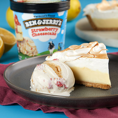 Slice of pie with a scoop of Strawberry Cheesecake ice cream next to it.