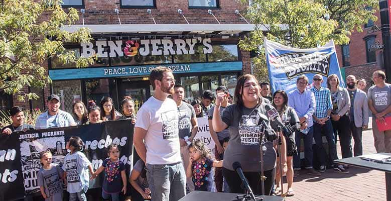 Thelma Gomez celebrates the signing of the Milk with Dignity contract in front of a Ben & Jerry's location with Migrant Justice activists and Ben & Jerry's leadership.